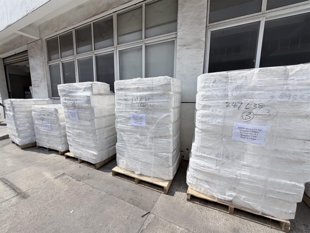 Bucket elevator parts including elevator buckets, bolts and belt clamps packed on wooden pallets for safe delivery