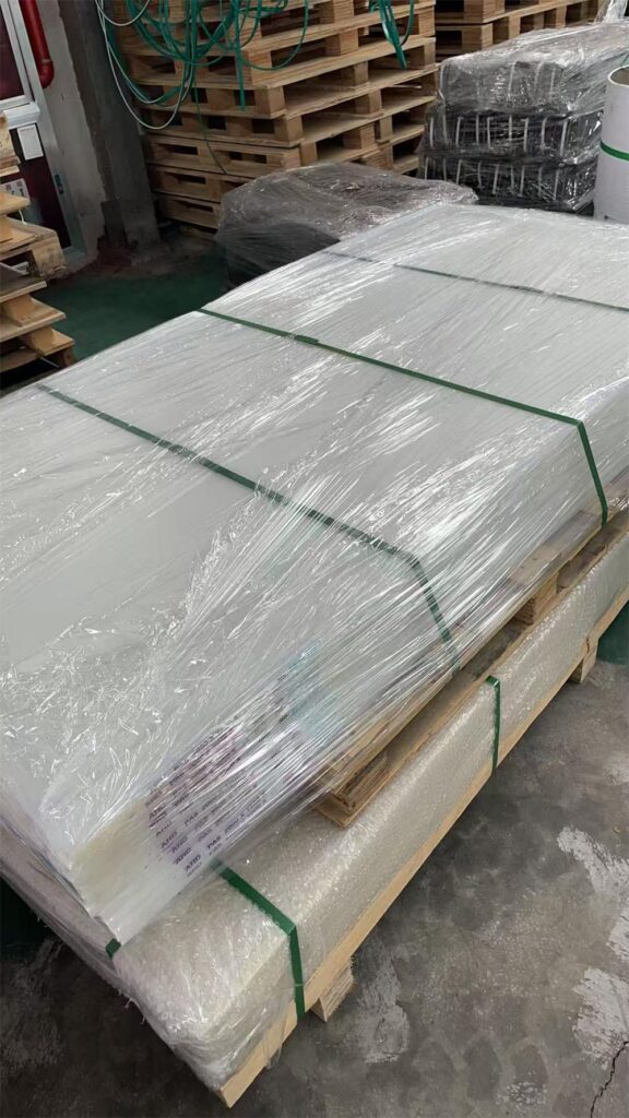 White PA6 and pale yellow PA66 nylon sheets packed on pallets for a Colombia order